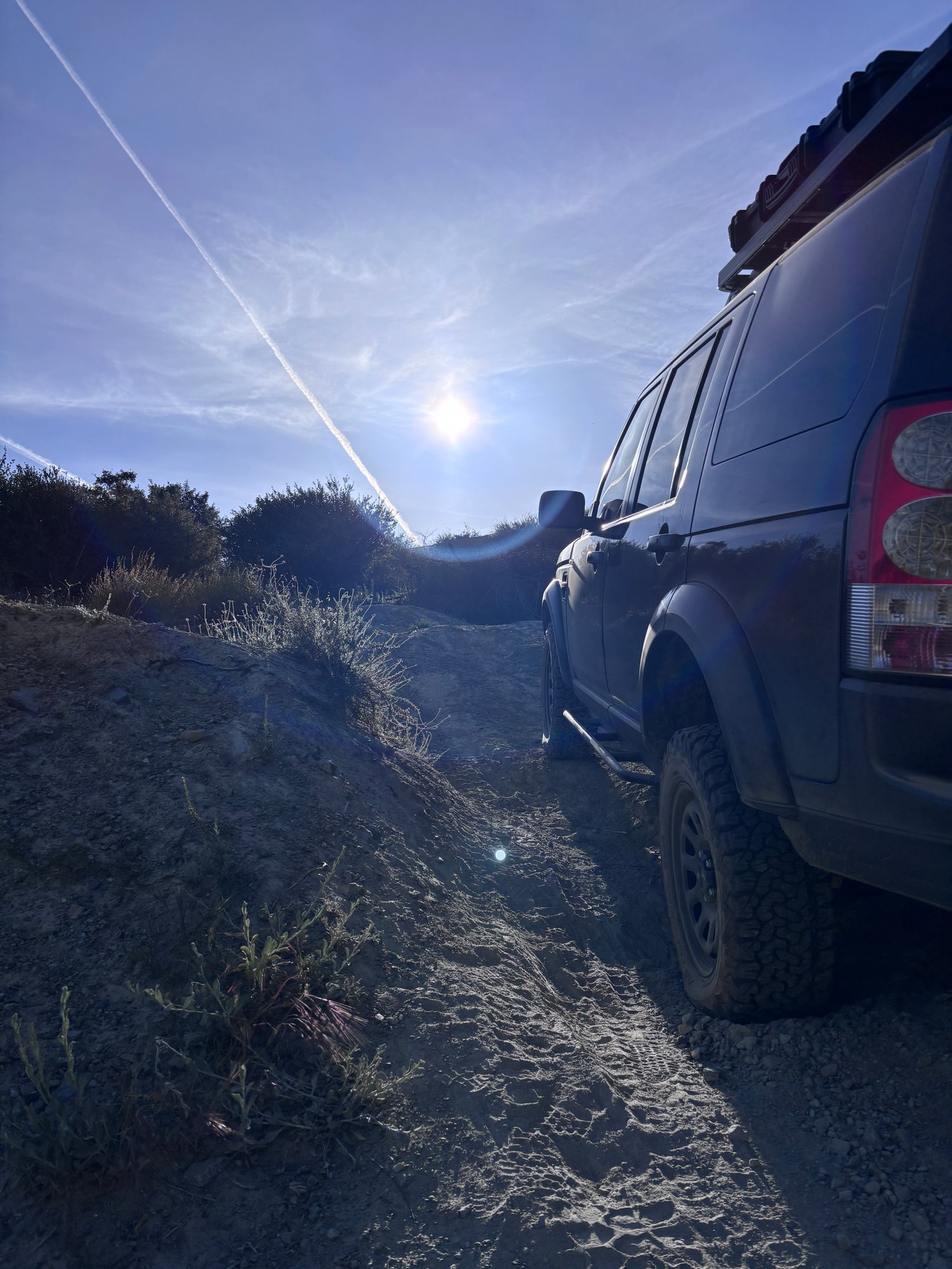 Car on a road with a scenic view of trees and sky